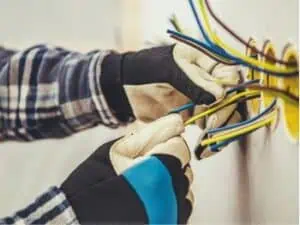 Commercial Wiring Upgrades An electrician is working on a wall with electrical wires