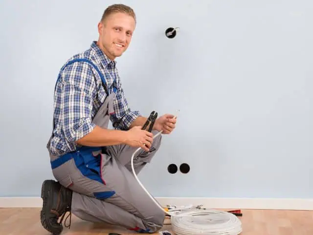 Electrician wiring a circuit in a Rockwall office